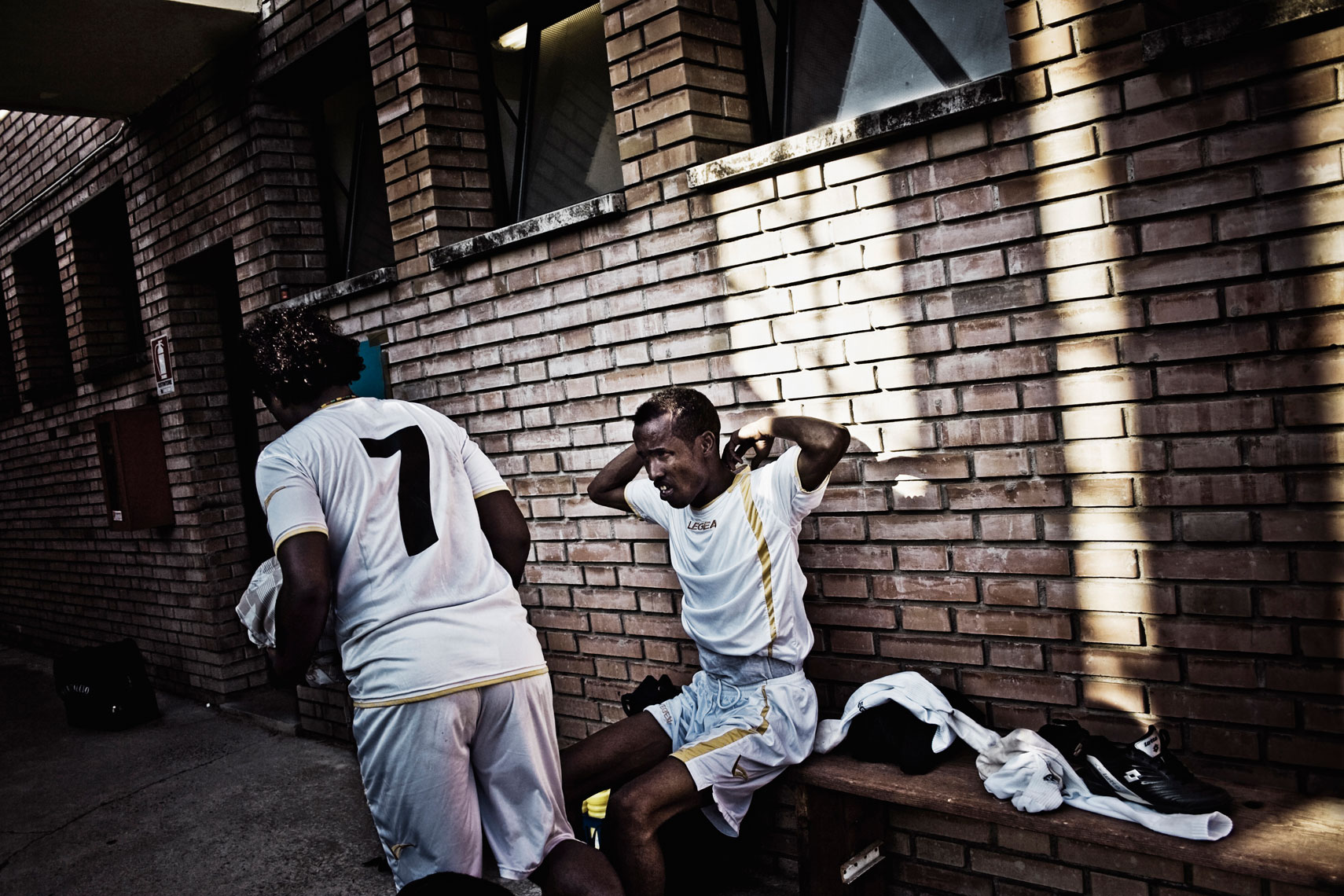 ITALY. Casalecchio di Reno, Bologna, 8th July 2010. During the "Anti-Racist World Cup". Two of the members of a soccer team composed by Somali refugees who are living in a shelter for refugees located in the building of the former "Hotel Real" in the outskirts of Florence.