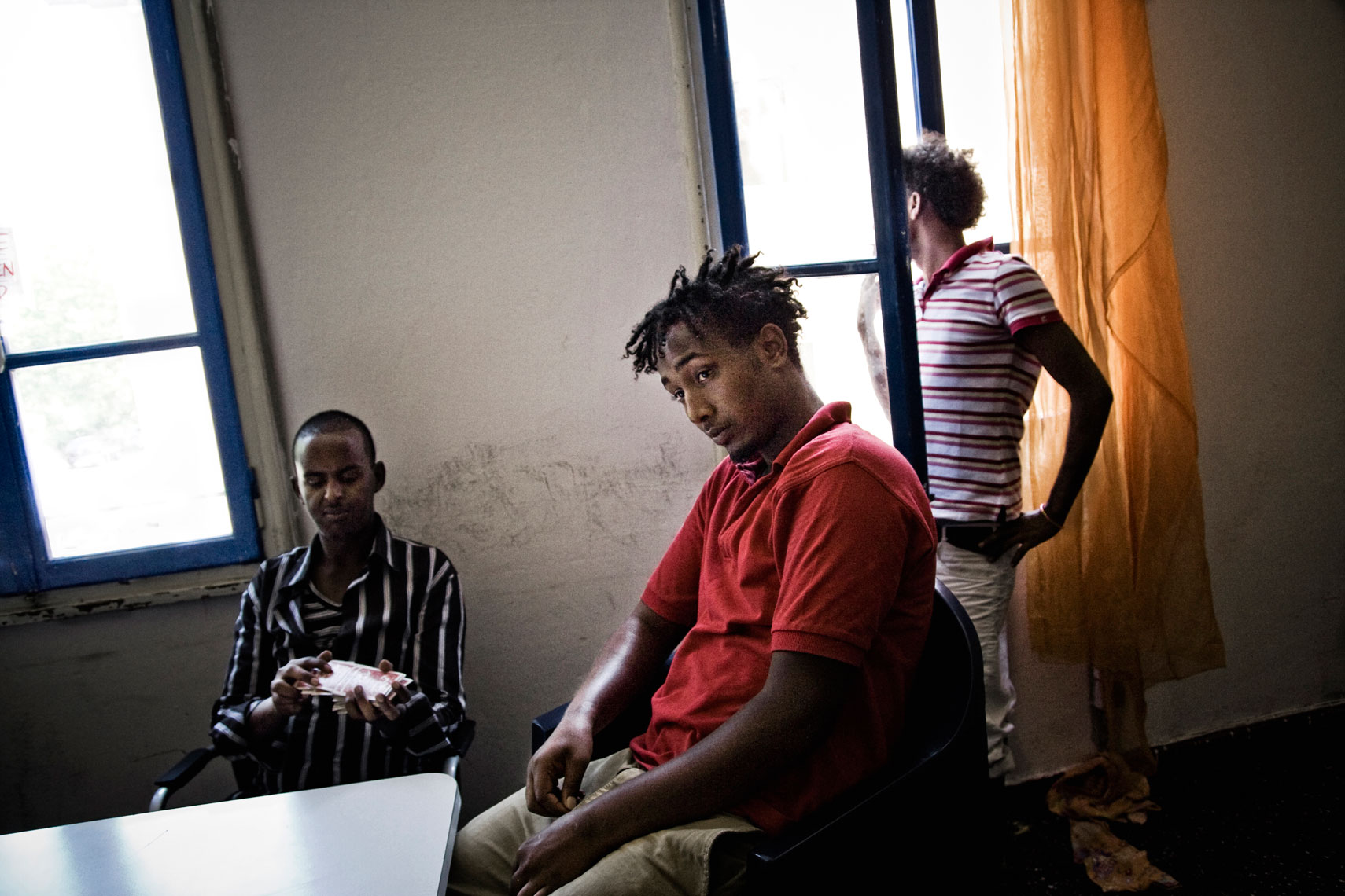 ITALY. Padua, 12th July 2011. Salmaan (centre) and other Somali refugees arrived in Italy from Libya in April, waiting for an Italian lesson inside the base of the Stop Racism Association.