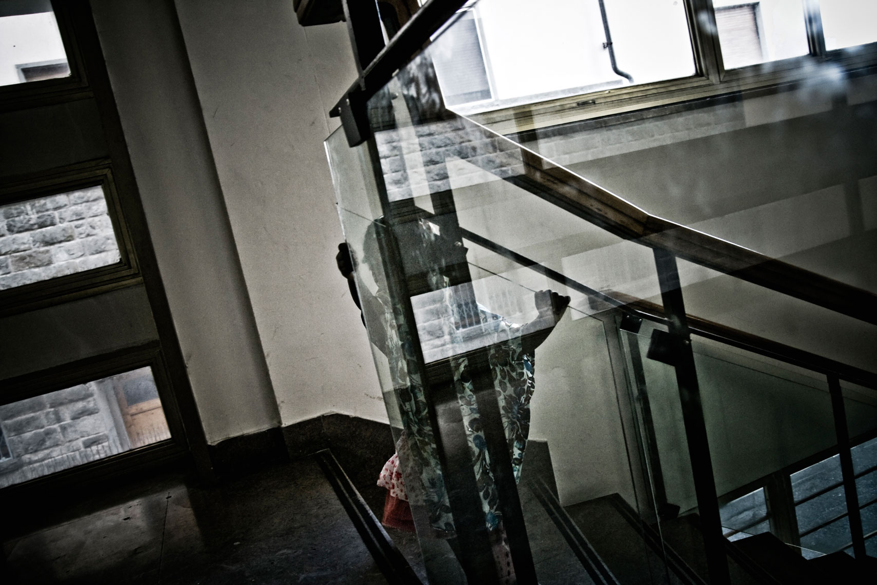 ITALY. Florence, 20th June 2011. A young Somali refugee plays on the stairs of a former office building occupied by Somali and Eritrean refugees.