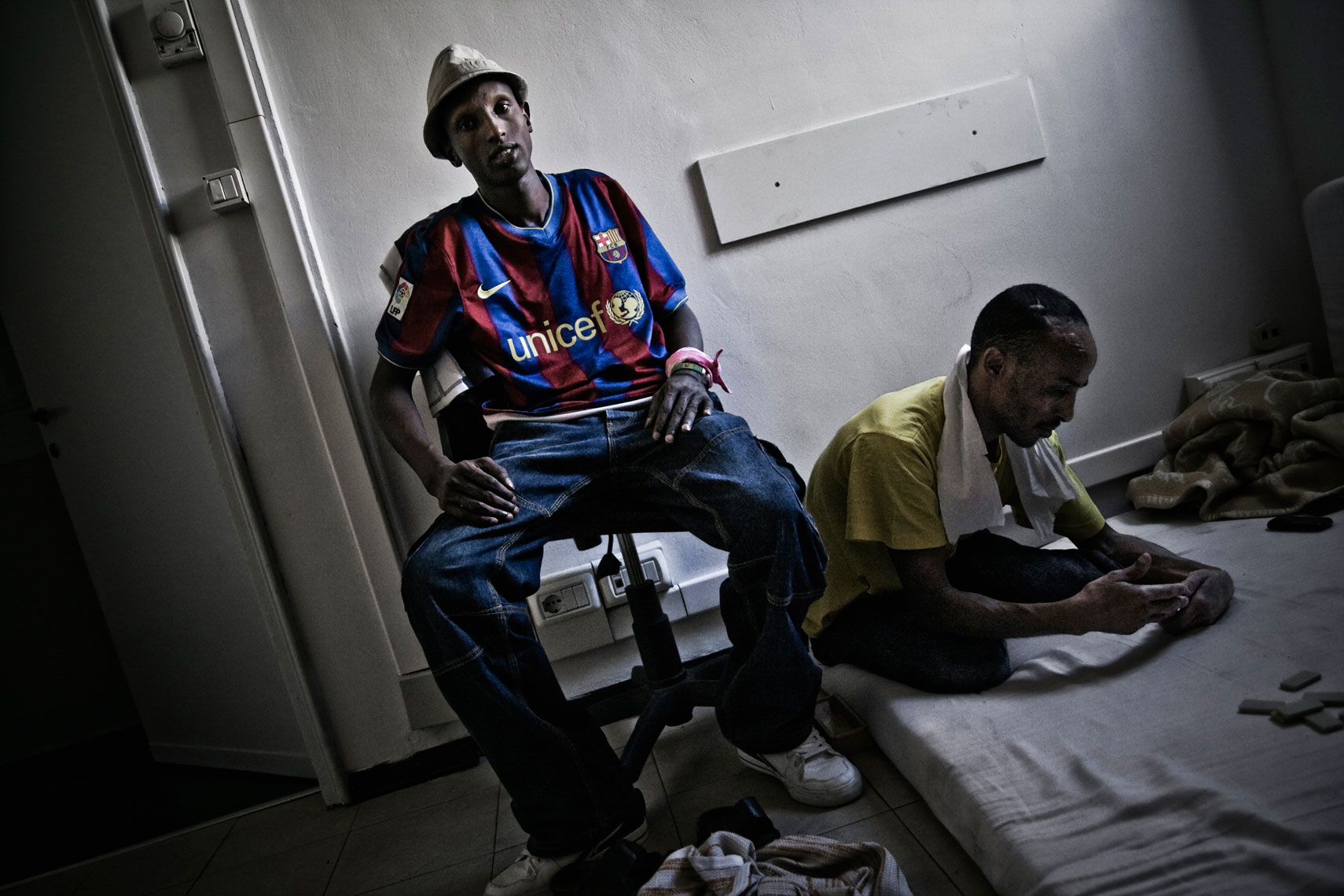 ITALY. Florence, 20th June 2011. Two somali refugees  inside a former office building squatted by somali and eritrean refugees.