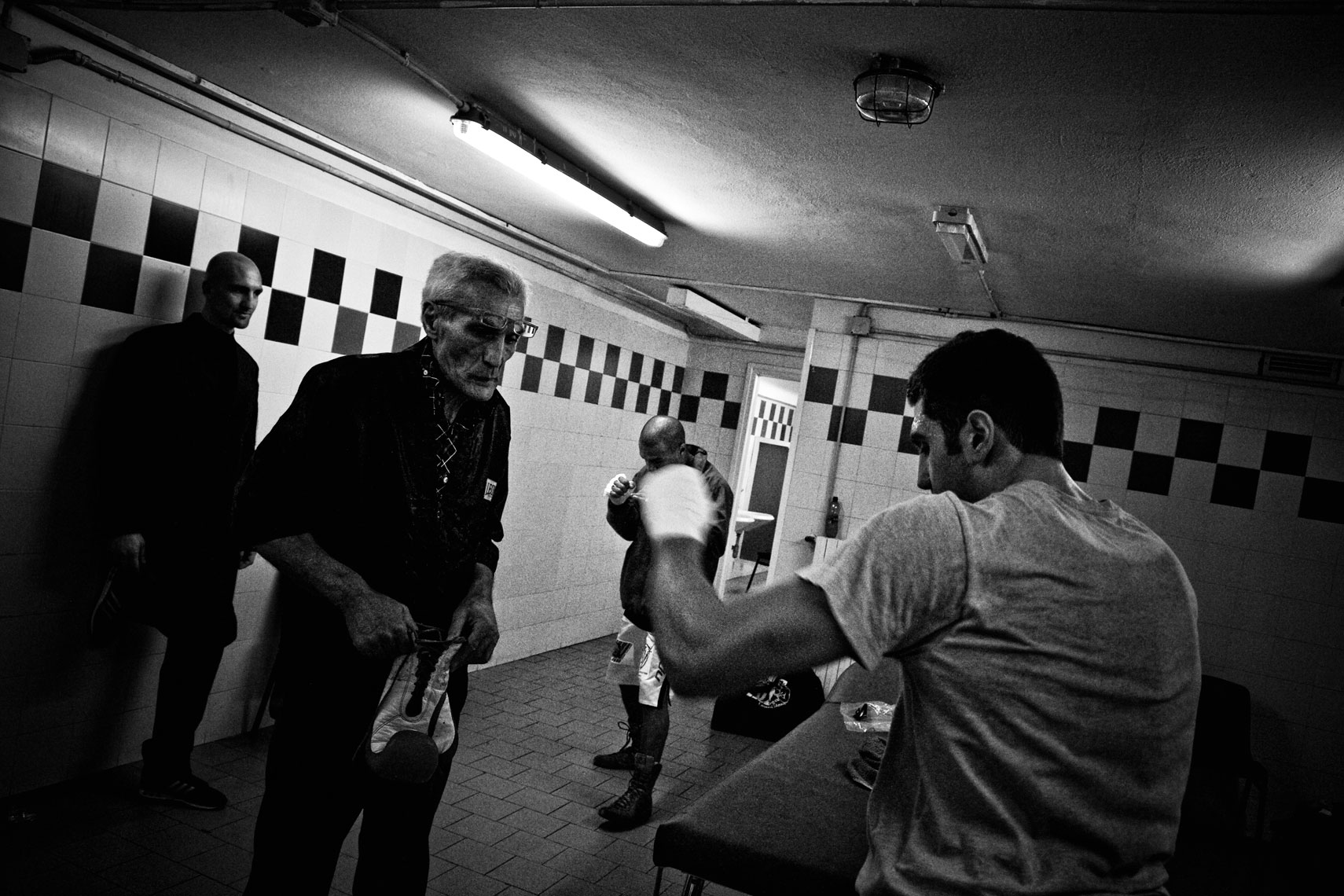 ITALY. Florence, 4th November 2011. Mandela Forum, the night of the match for the EBU (European Boxing Union) Welter Weight crown, Leonard Bundu warming up for the match. On the right Mr. Fiordigiglio, another boxer signed with Mr. Loreni agency, warming up with his trainer (on the left) to fight in a match before the EBU one.