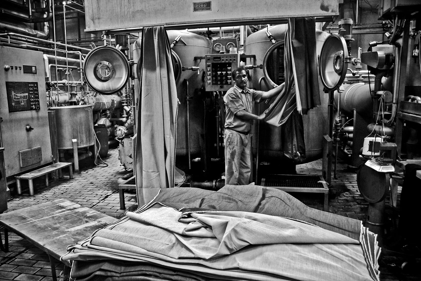 ITALY. Prato, 31st March 2009. Worker using dyeing machines.